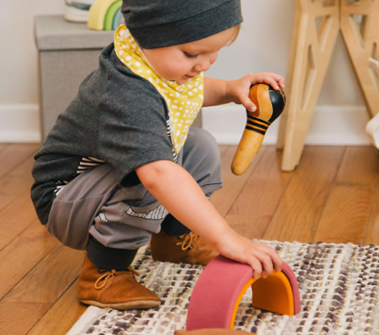 baby playing in colorful ethical clothing