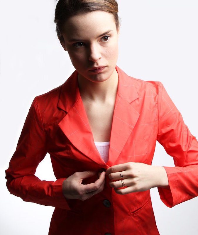 Photo of a woman wearing the Reflective Blazing Blazer in Cinnabar Red from Vespertine