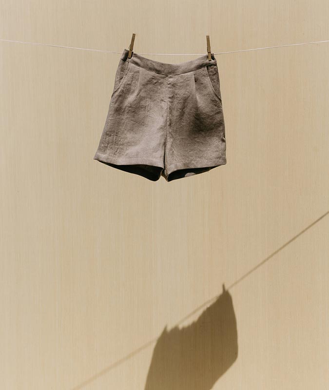 Photo of the Isamu short in flax linen hanging on a clothesline