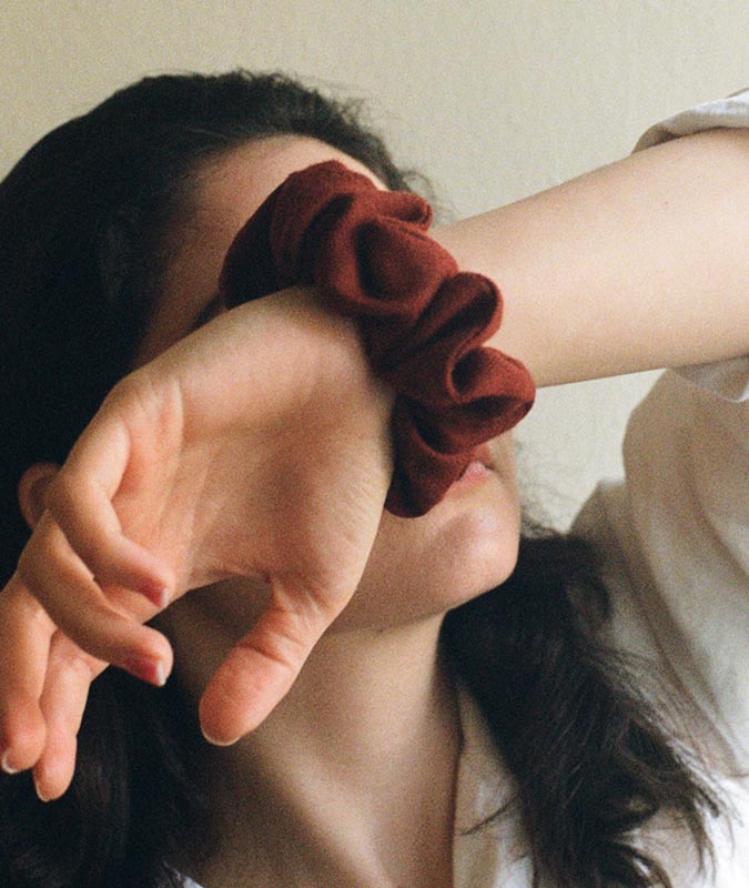 Photo of the Crimson Wool Scrunchie on a woman's wrist